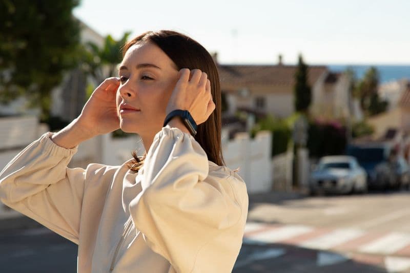 Woman standing with Apple Watch